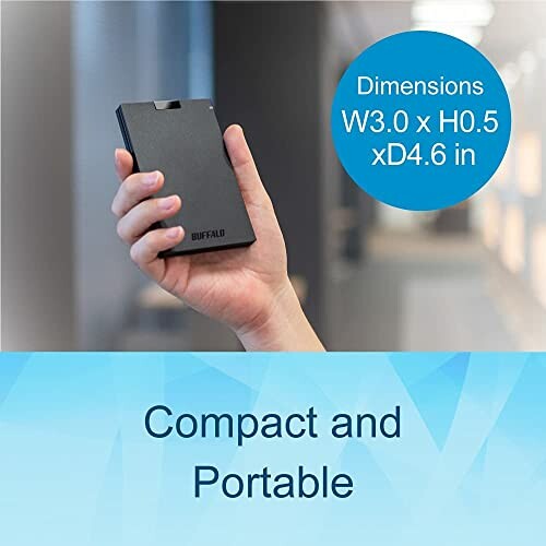 Hand holding compact portable hard drive with dimensions.